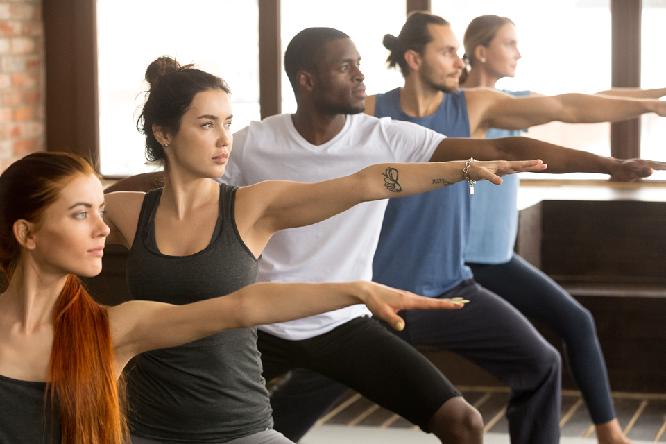 Group of people exercising in a yoga class